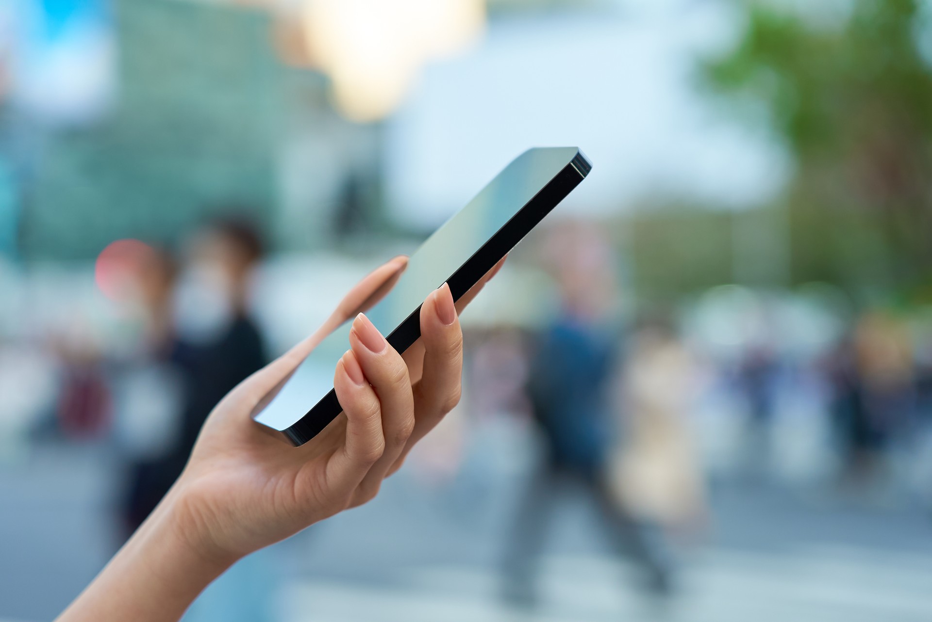 a woman operating a smartphone in a downtown area